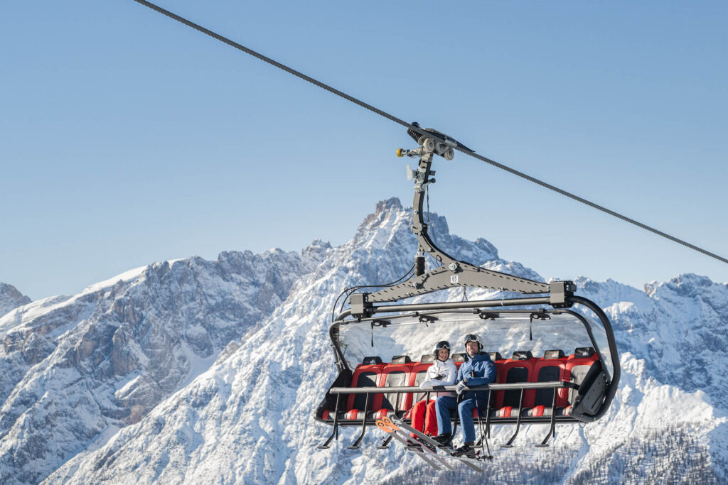 Skiers on a chairlift at 3 Zinnen Dolomites