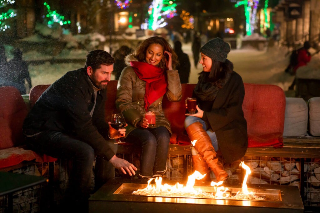 group of friends around fire pit in Whistler Village