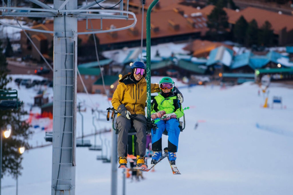 Family taking chairlift up Angel Fire Resort