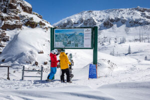 ski couple reading trail map at Brian Head Ski Resort