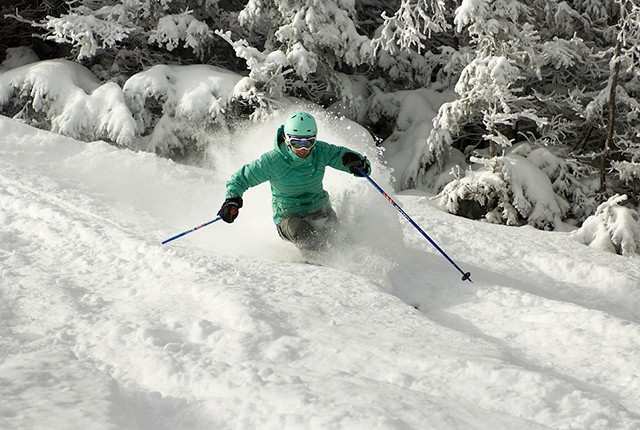 Cannon Mountain, NH skier in powder, spring skiing.