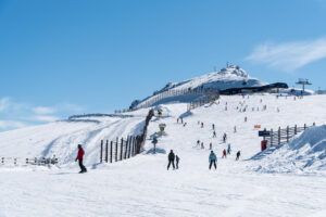 Sunny day at busy slopes of Cardrona Ski Area in New Zealand