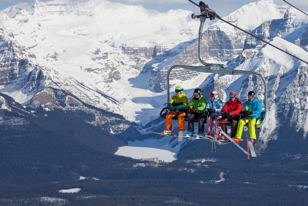 Skiers on lift in the Canadian Rockies at Lake Louise