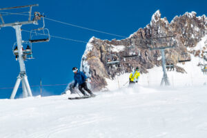 Skiing down Palmer Snowfield at Timberline Lodge on a sunny day