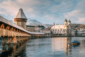 The city of Lucerne - Chapel Bridge and Water Tower. Mount Pilatus and the Jesuitchurch in the background