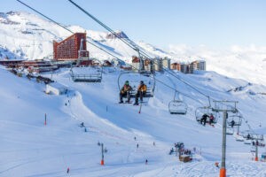 Skiers riding chairlift up Valle Nevado