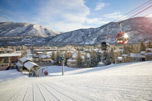 Exterior of The Little Nell hotel at the base of groomed slopes of Aspen