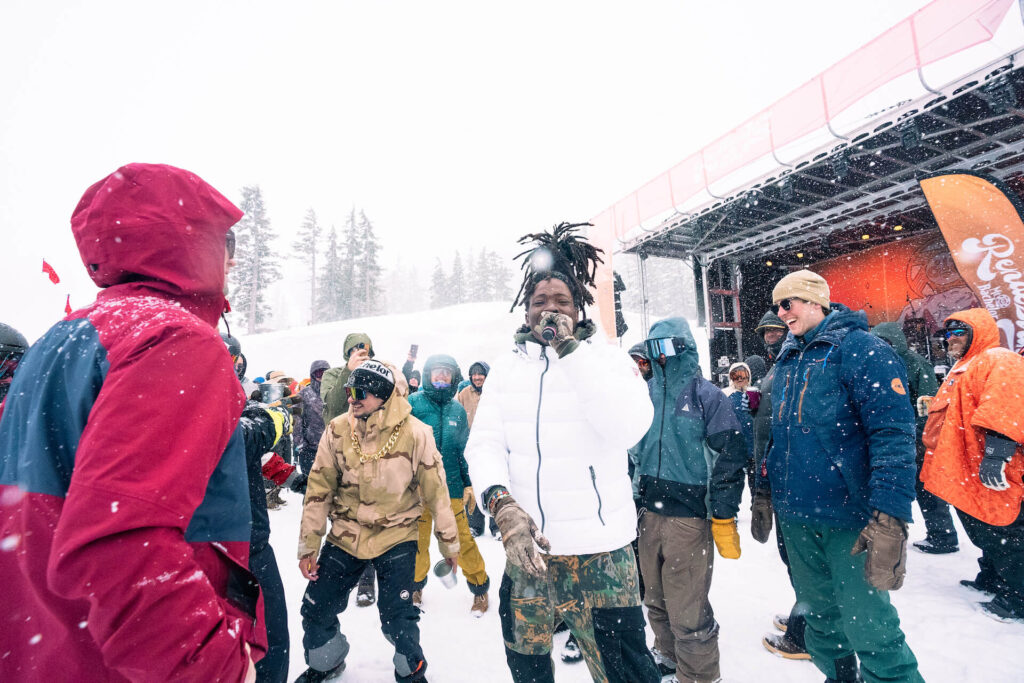 Group of people singing and dancing outside on the snow at Mt. Bachelor