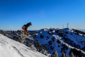 Person skiing down run on a bluebird powder day at Bogus Basin