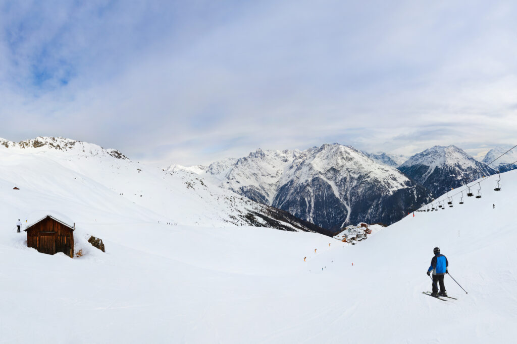 Sölden Austria ski resort covered in snow with a skier skiing down a run