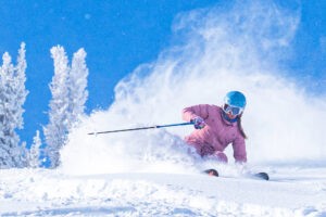 When Should You Buy a Ski Pass? Aspen Snowmass female skier.