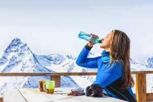 Woman drinking water mountains